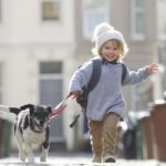 Young child running with dog