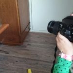 Girl Photographing Cat At Home