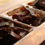 Biltong (dried meat) on a wooden board, this is a traditional food snack that can be found in South Africa.