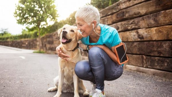 Mature woman jogging with her dog