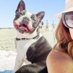Young Women With Boston Terrier Enjoying At Beach
