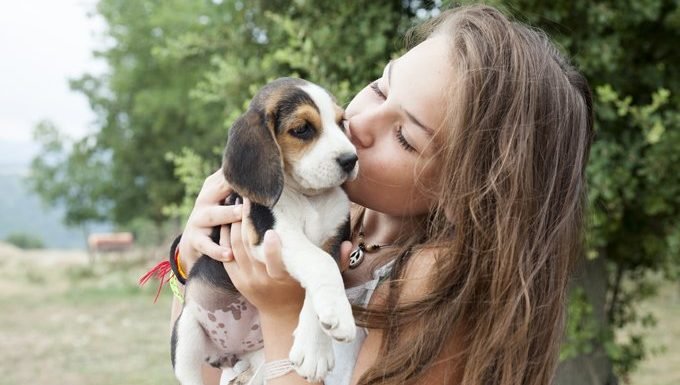 girl holding a puppy