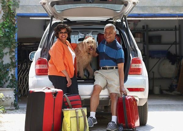 Black couple loading car for vacation