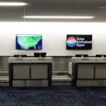 FLORIDA, UNITED STATES - JULY 7: An empty ticket counter with weather maps displayed is seen at Tampa International Airport which closed from 5:00 p.m. until 10:00 a.m as Tropical Storm Elsa moves northward toward the Tampa Bay area on July 6, 2021 in Clearwater Beach, Florida, United States. Storm is expected to make landfall on Florida