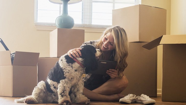USA, Florida, Jupiter, junge Frau mit Hund in ihrem neuen Haus