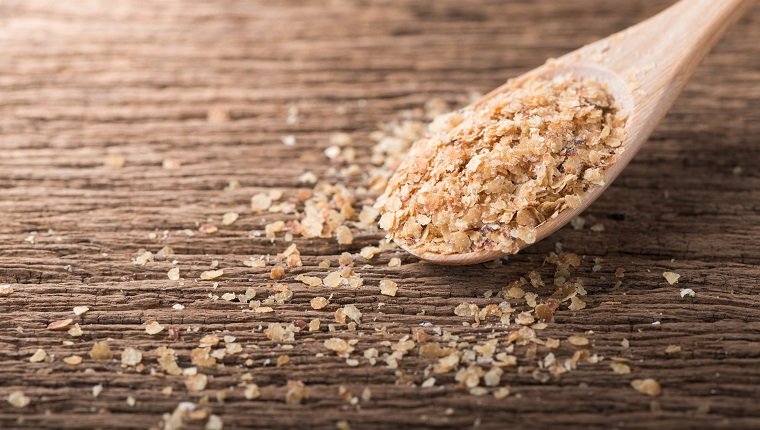 Wheat germ on wood spoon and wood background