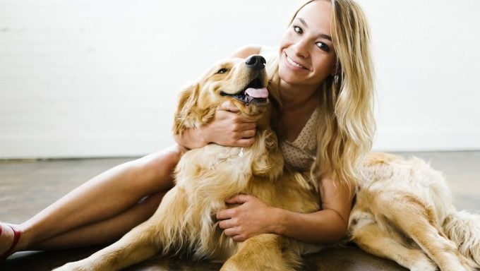 Frau umarmt Golden Retriever beste Hunderassen für einen Wassermann